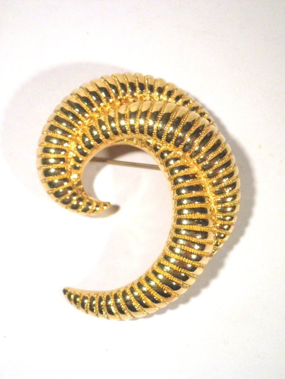 Vintage Monet gold-tone curved ribbed horn brooch